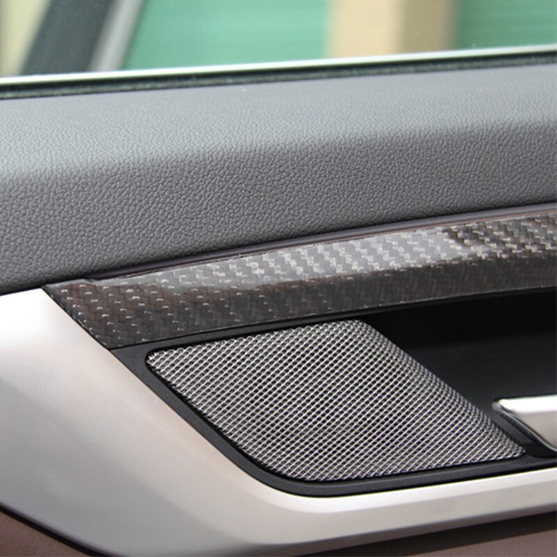 Close-up of gloss carbon door trim above the speaker grille – BMW F90 M5 and G30 5 Series