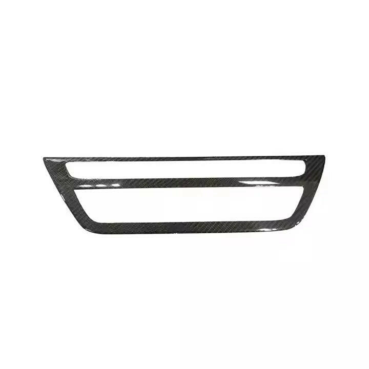Carbon trim frame for the radio and climate panel, from the front, on a white background – BMW F90 M5 and G30 5 Series