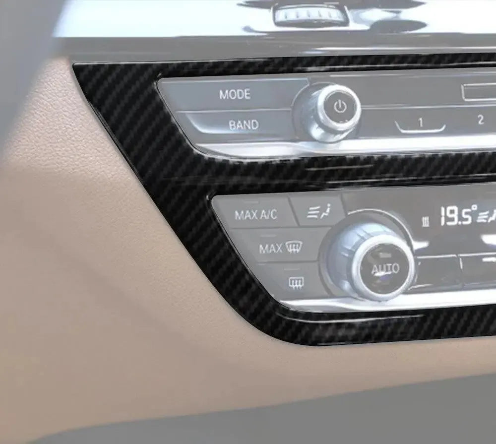 Close-up of beige interior with carbon trim installed around the radio and climate controls – BMW F90 M5 and G30 5 Series
