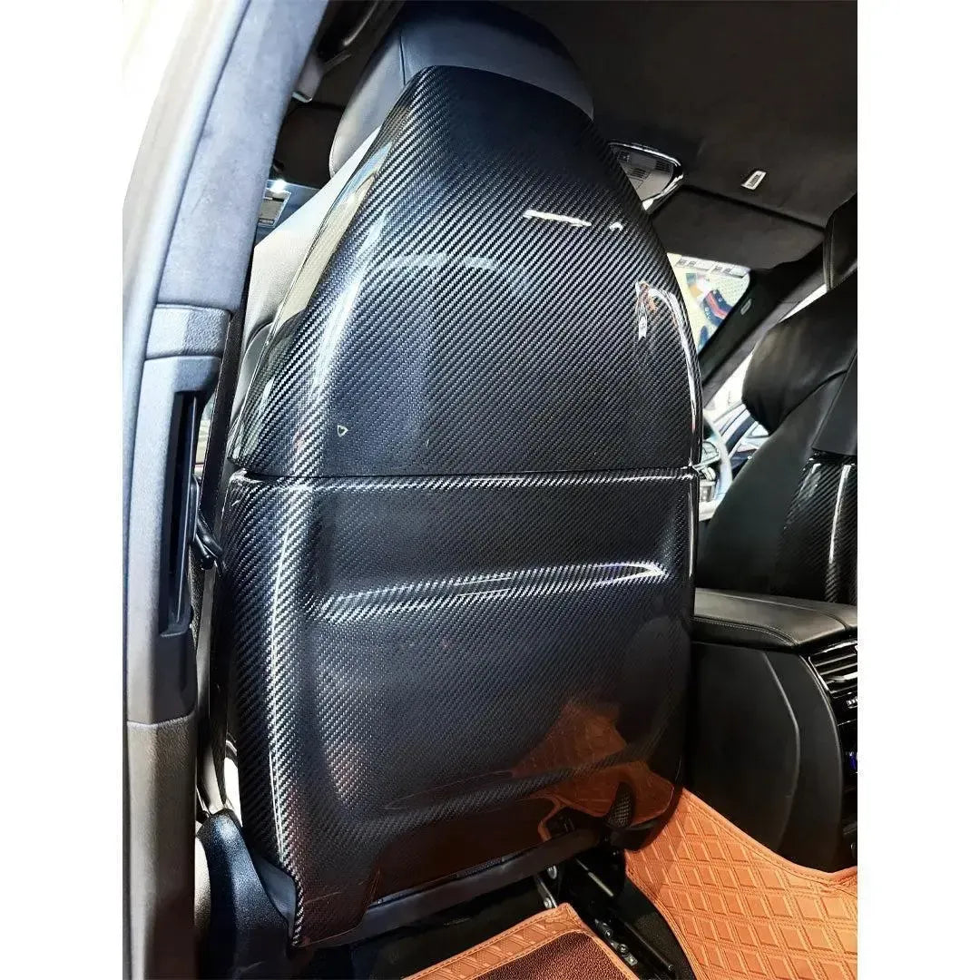 Carbon seat back cover fitted to a BMW F90 M5 front seat, rear view