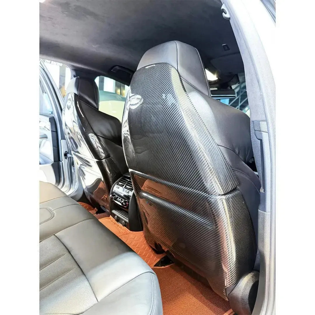Carbon seat back cover of the BMW F90 M5 front seat, viewed from the rear seats