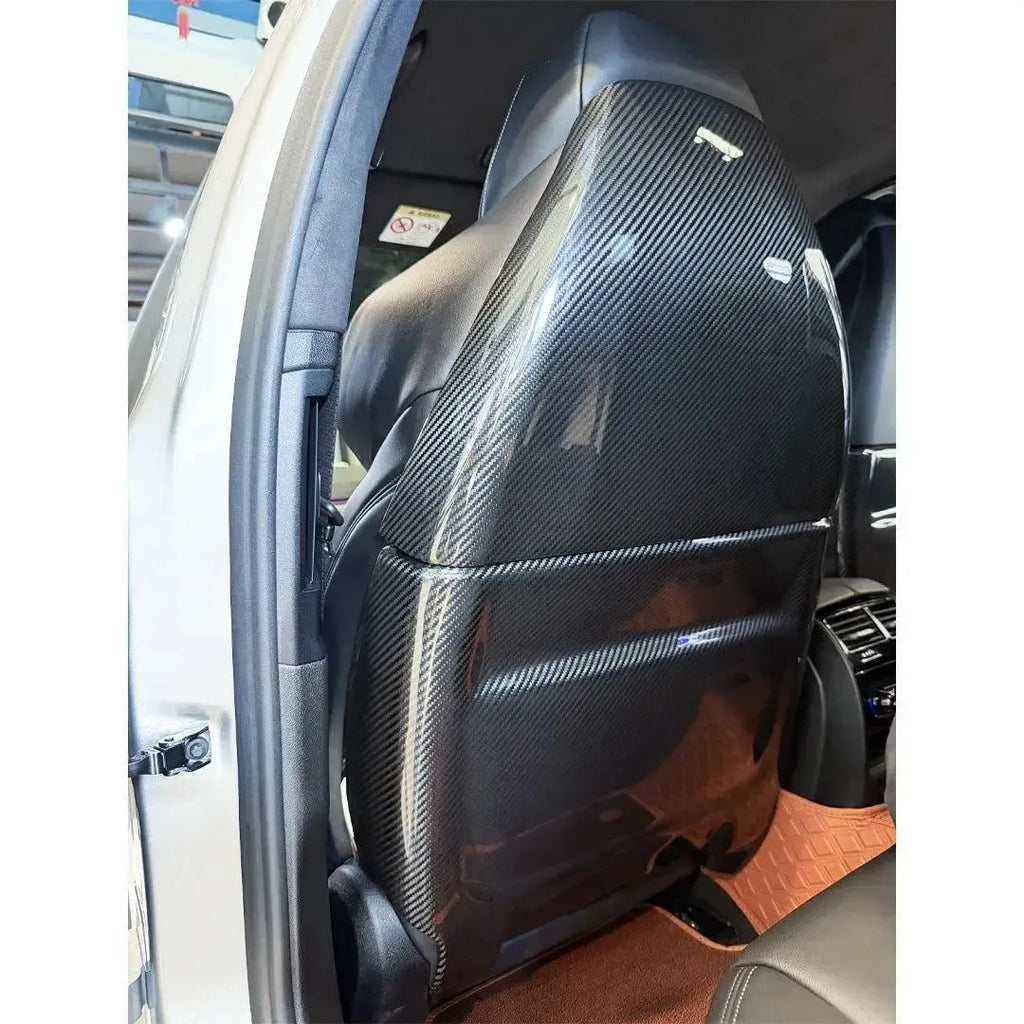 Full carbon seat back cover fitted to the front seat, rear three-quarter view – BMW F90 M5
