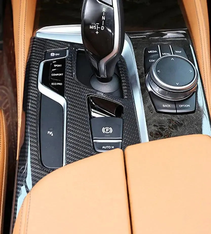 BMW G30 interior from above: installed carbon gear shift panel trim, with light brown leather