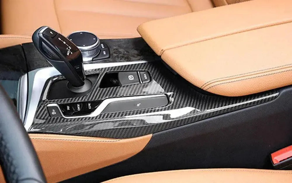 BMW G30 with light brown leather interior and installed carbon gear shift panel trim, side view