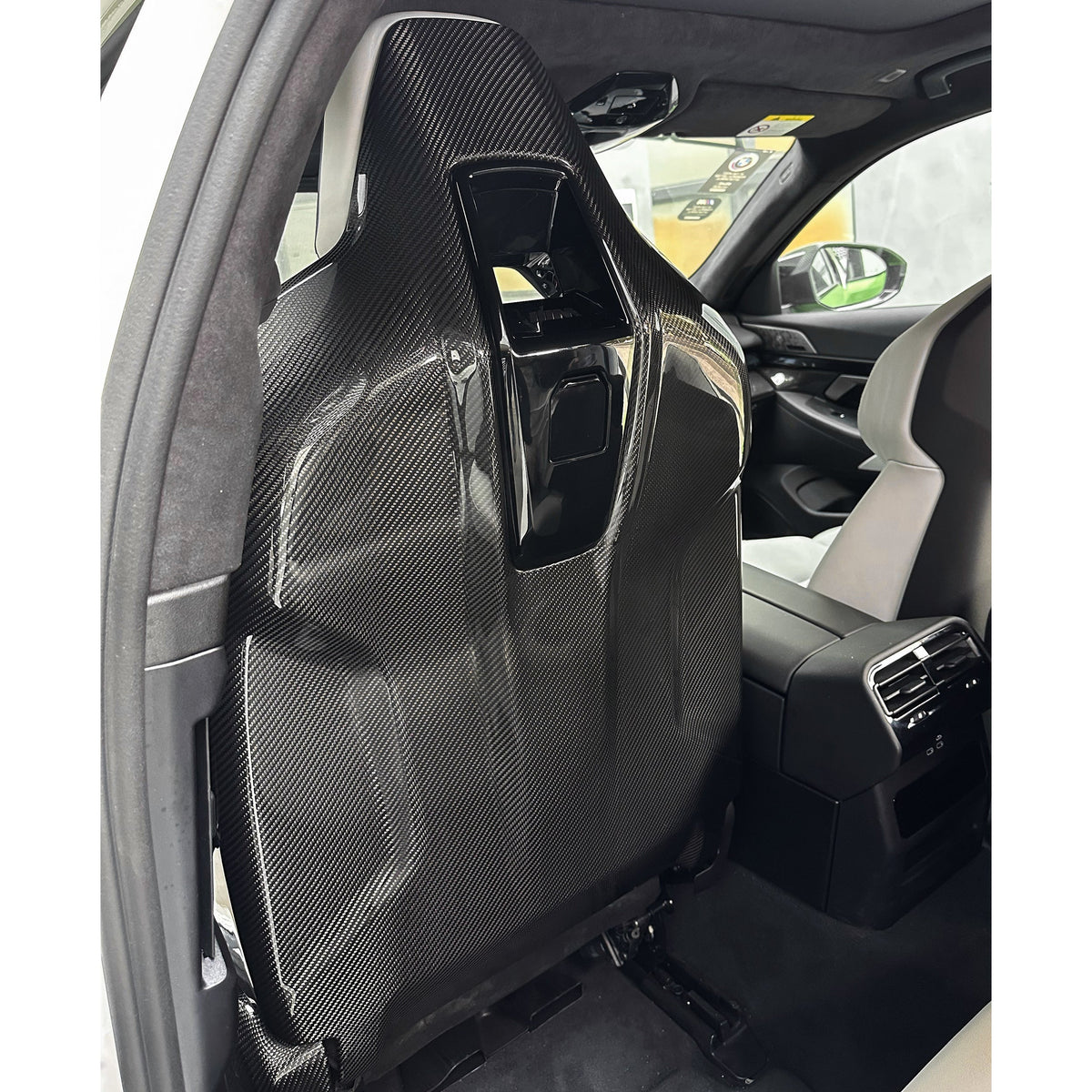 Full carbon seat back cover fitted to the front seat, rear three-quarter view – BMW G90 M5
