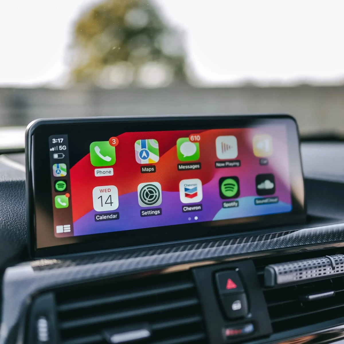 Apple CarPlay home screen icons on the factory display, close-up – BMW F87 M2