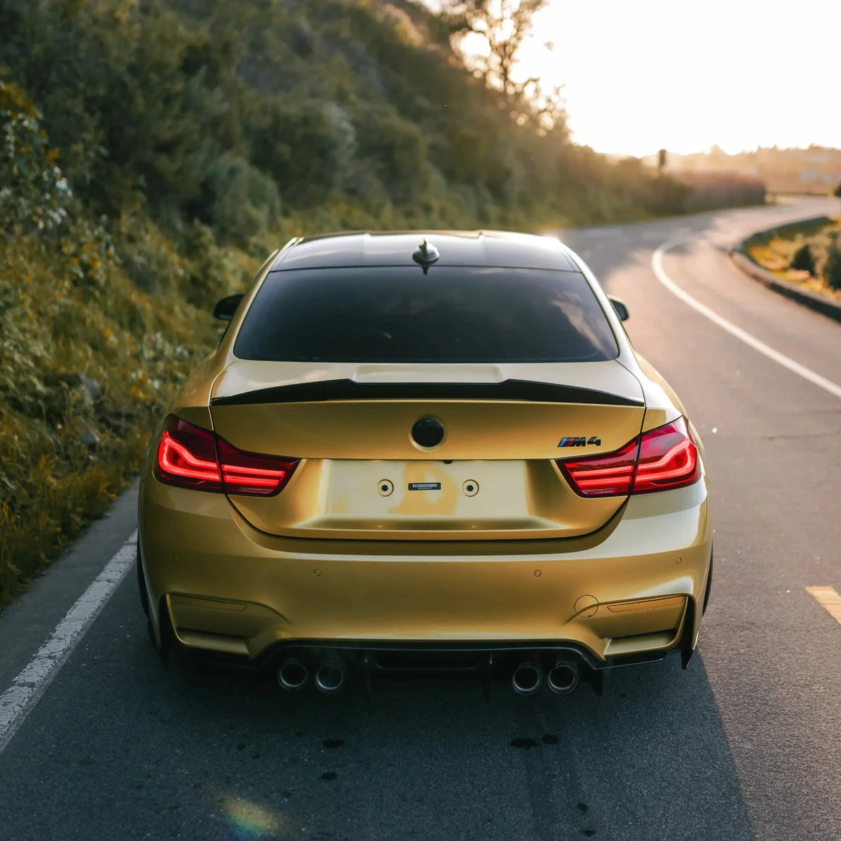 Yellow BMW F82 M4 from behind, carbon trunk spoiler and rear diffuser (Laptor + PSM Style)