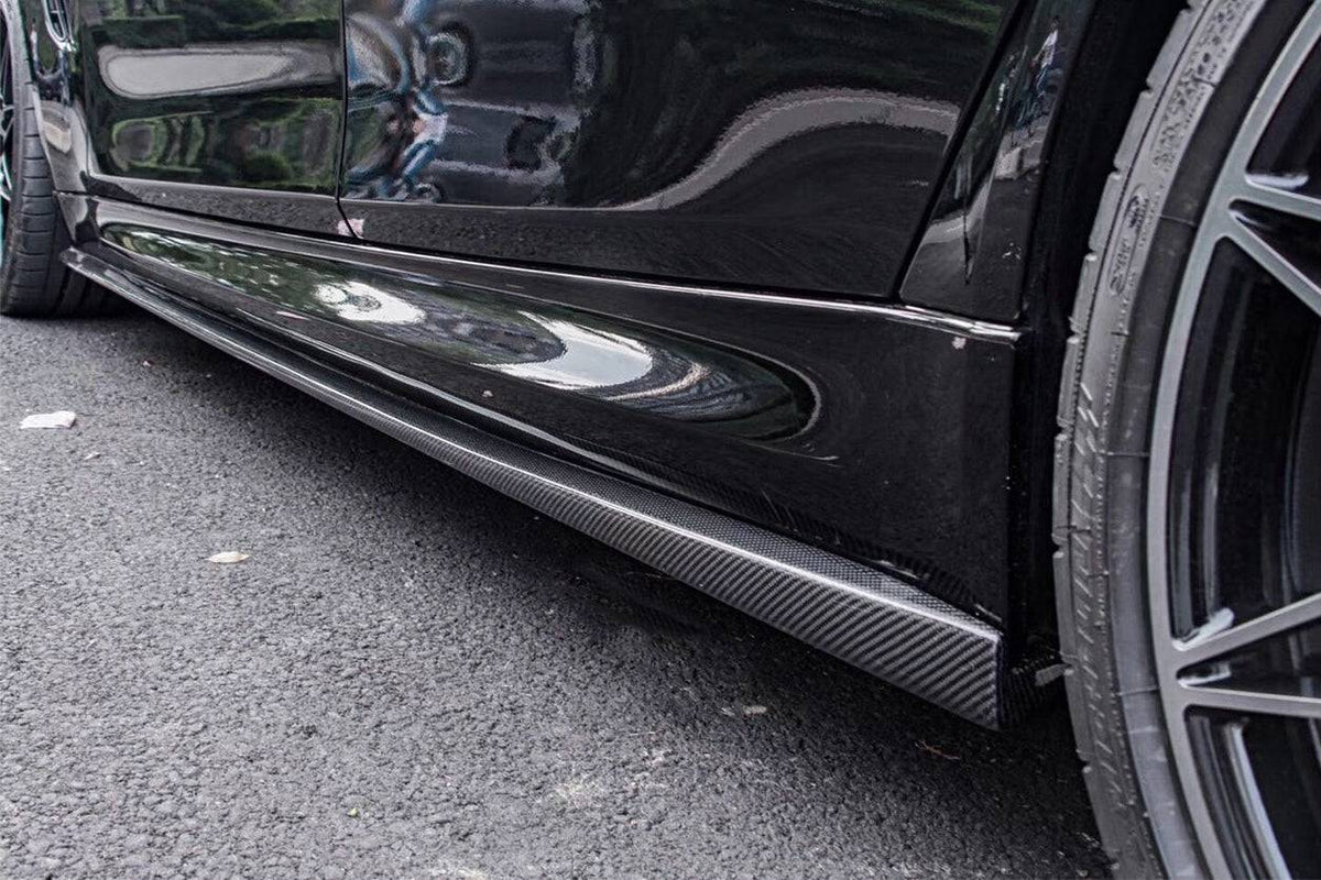 Side of a black BMW F80 M3, close-up, with fitted carbon side skirt (VA Style)