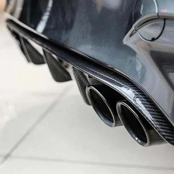 Gray BMW M3/M4 rear close-up, with finned carbon diffuser and four exhausts (Performance Style)
