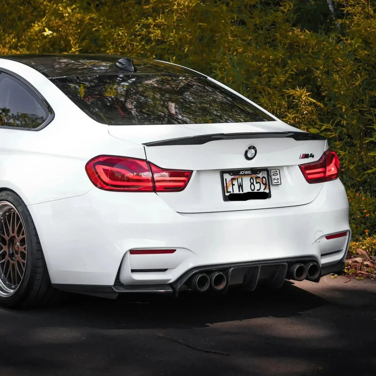 White BMW F82 M4 from a rear angle, with fitted carbon rear diffuser (V Style)