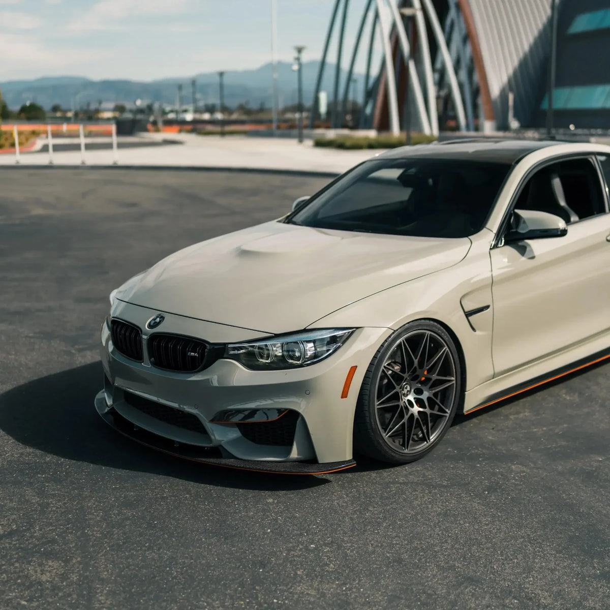 Gray BMW F82 M4 from a front angle, close-up, fitted carbon front lip (3D Style)