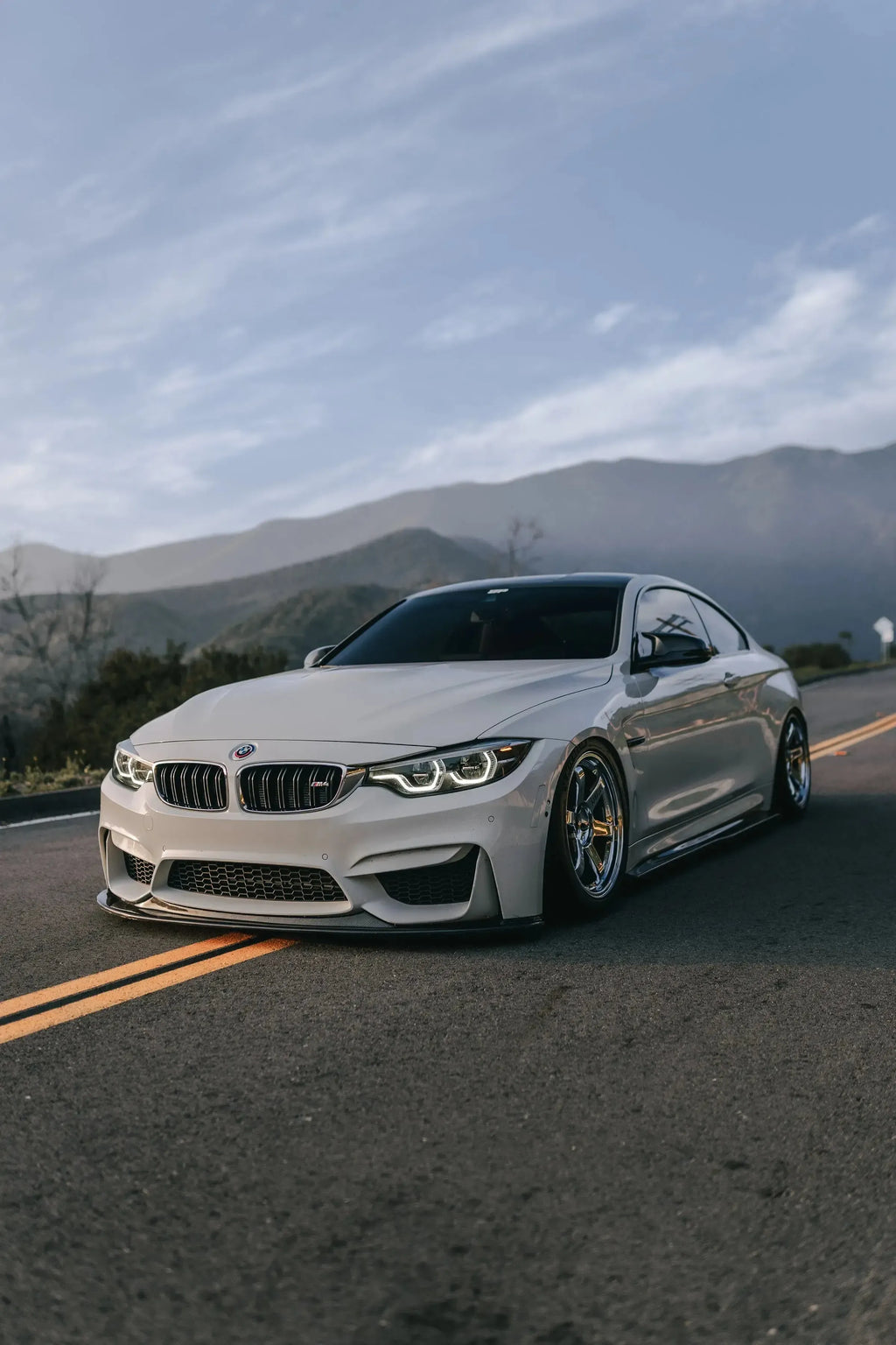 White BMW F82 M4, angled front view, fitted carbon front lip (K Style)