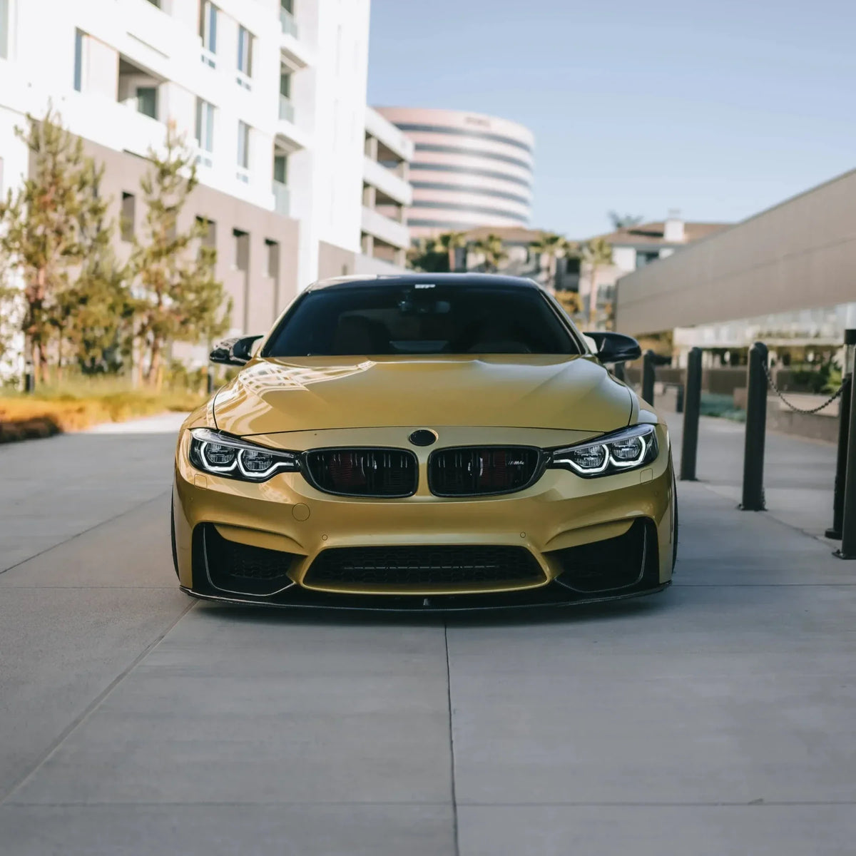 Yellow BMW F82 M4 head-on, with fitted carbon fiber front lip (MP Style)