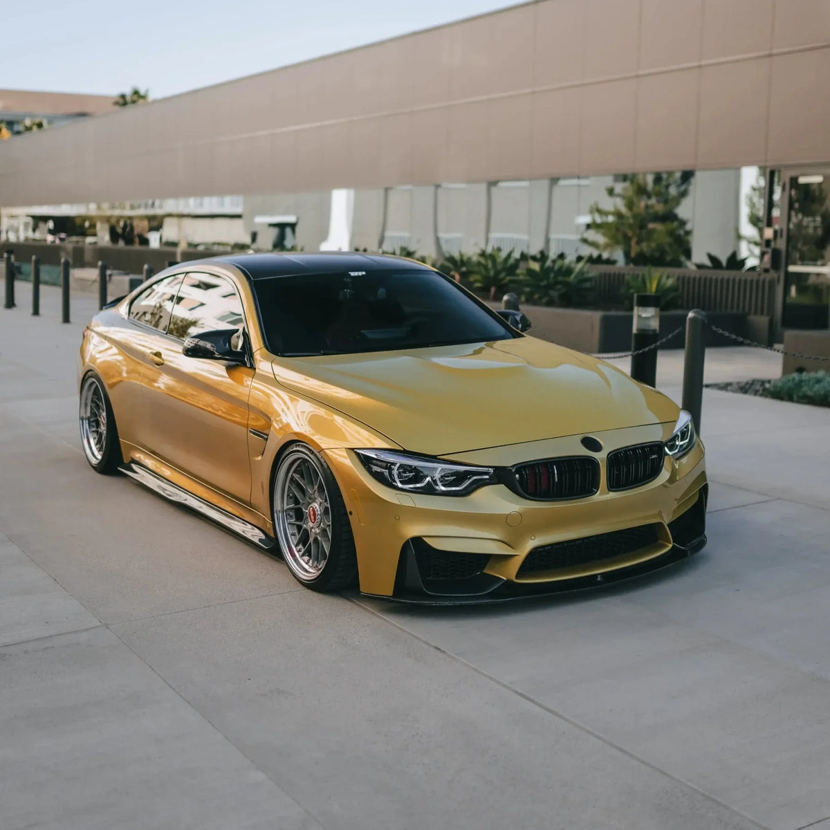 Yellow BMW F82 M4 from a front angle, fitted carbon fiber front lip (MP Style)