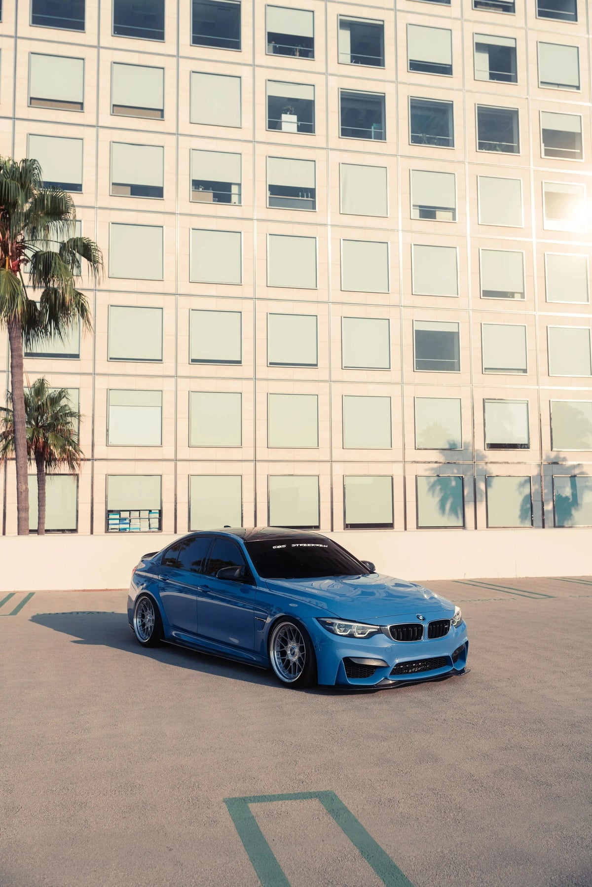Blue BMW F80 M3 from further away, angled front view, with carbon front lip (PSM Style)