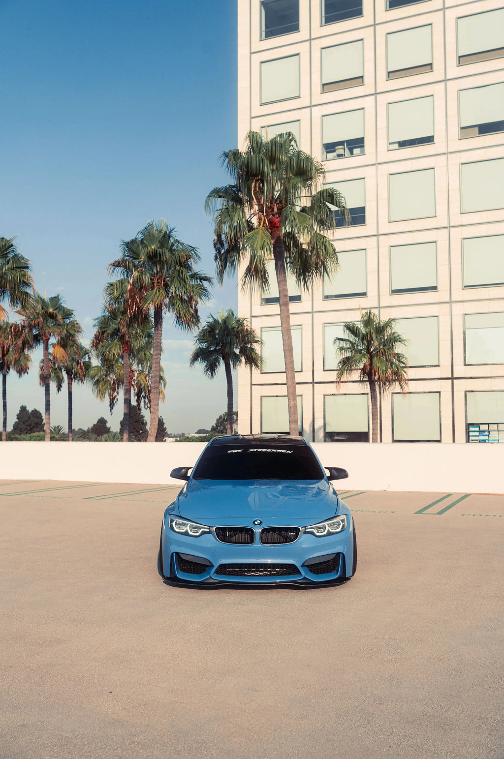 Blue BMW F80 M3 straight head-on, from a distance, with carbon front lip (PSM Style)