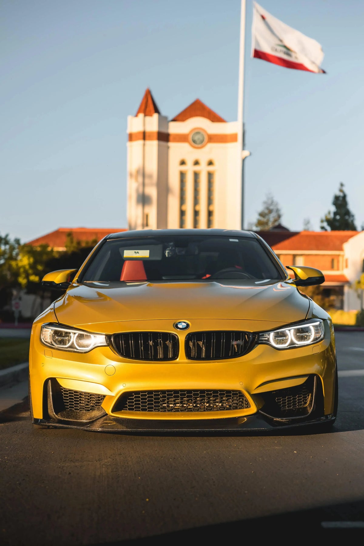 Yellow BMW F82 M4 straight head-on, with carbon fiber front lip (RSC Style)