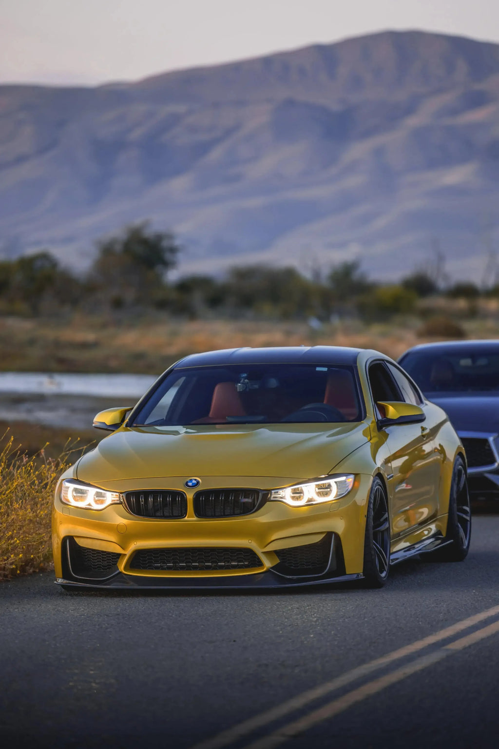 Yellow BMW F82 M4 on the move, head-on, fitted carbon front lip (RSC Style)