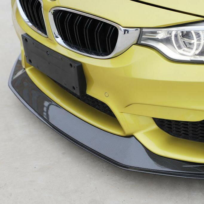 Yellow BMW F82 M4 front bumper close-up, with fitted carbon lip (V1 Style)