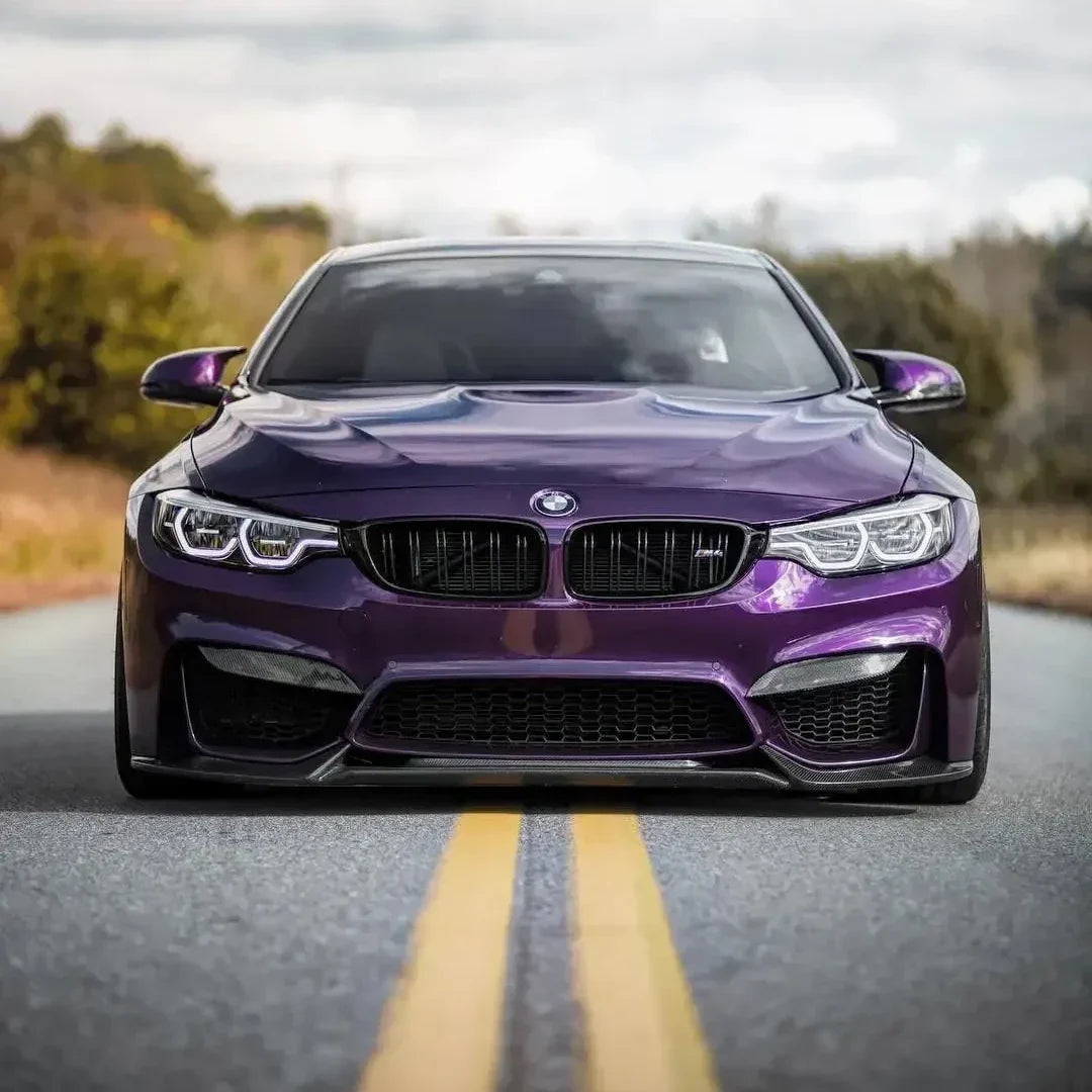 Purple BMW F82 M4 head-on on the road, with carbon fiber front lip (VRS Style)