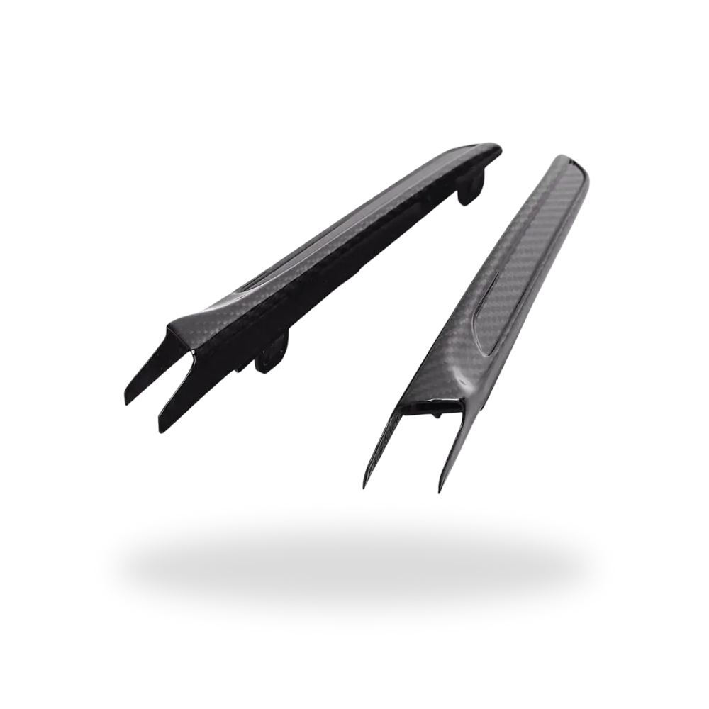 Two carbon fender vent trims on a white background, from an angle – BMW F80 M3 / F82 M4