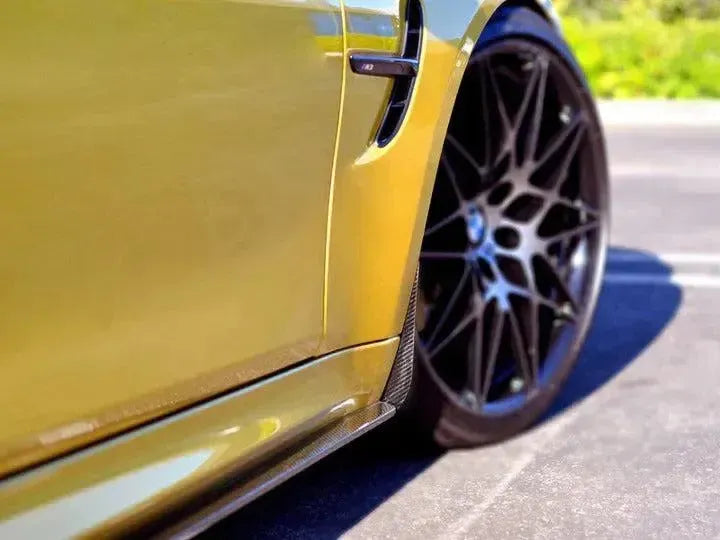 Carbon front mud flap installed behind the wheel, yellow BMW F82 M4