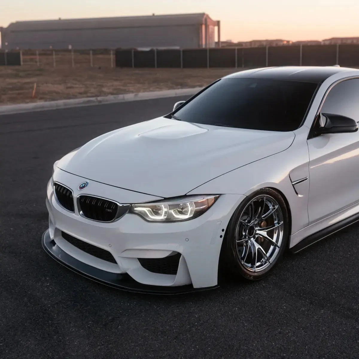 White BMW F82 M4 three-quarter close-up, LED headlights with white angel eyes (LCI Ikon Style)