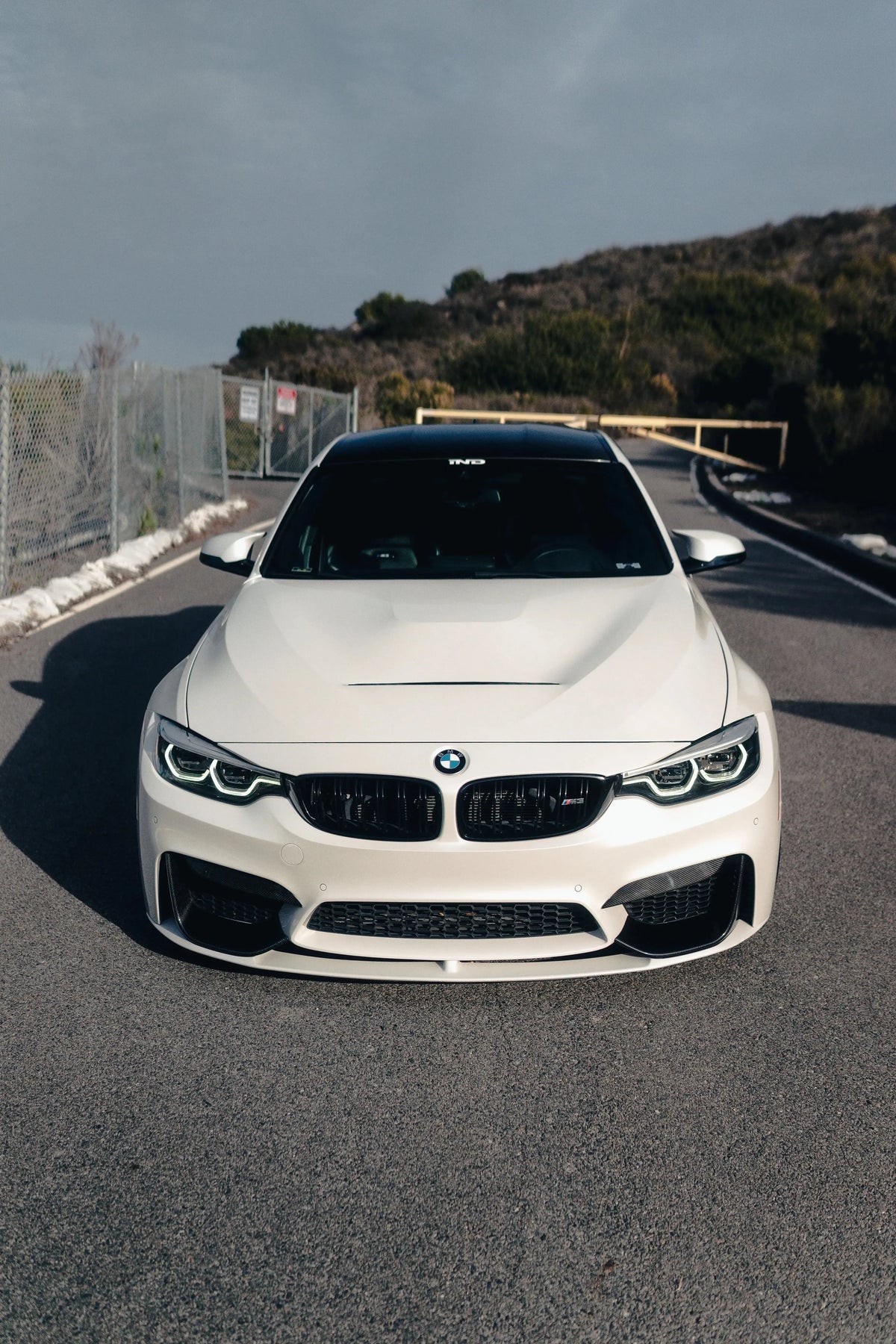 White BMW F82 M4 straight from the front, with vented aluminum hood (GTS Style)