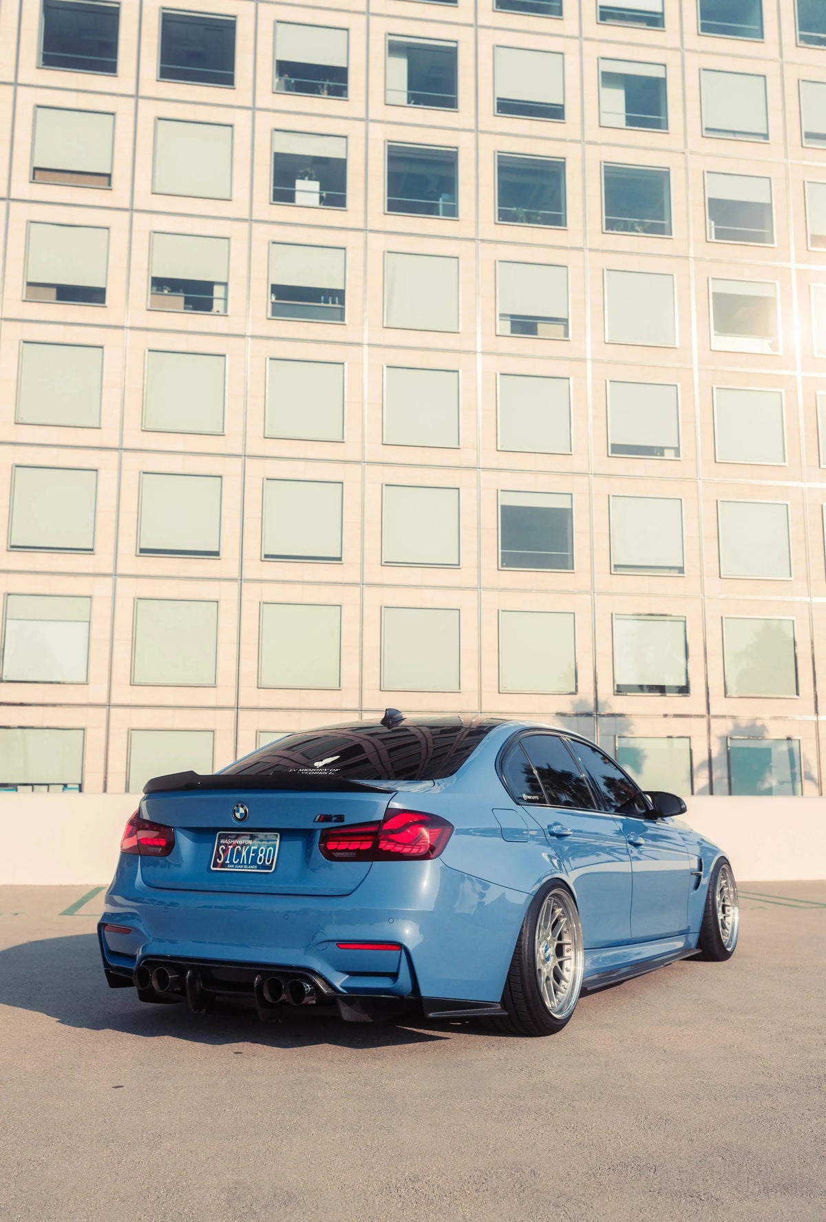 Blue BMW F80 M3 from a rear three-quarter angle, with red OLED tail lights (GTS Style)