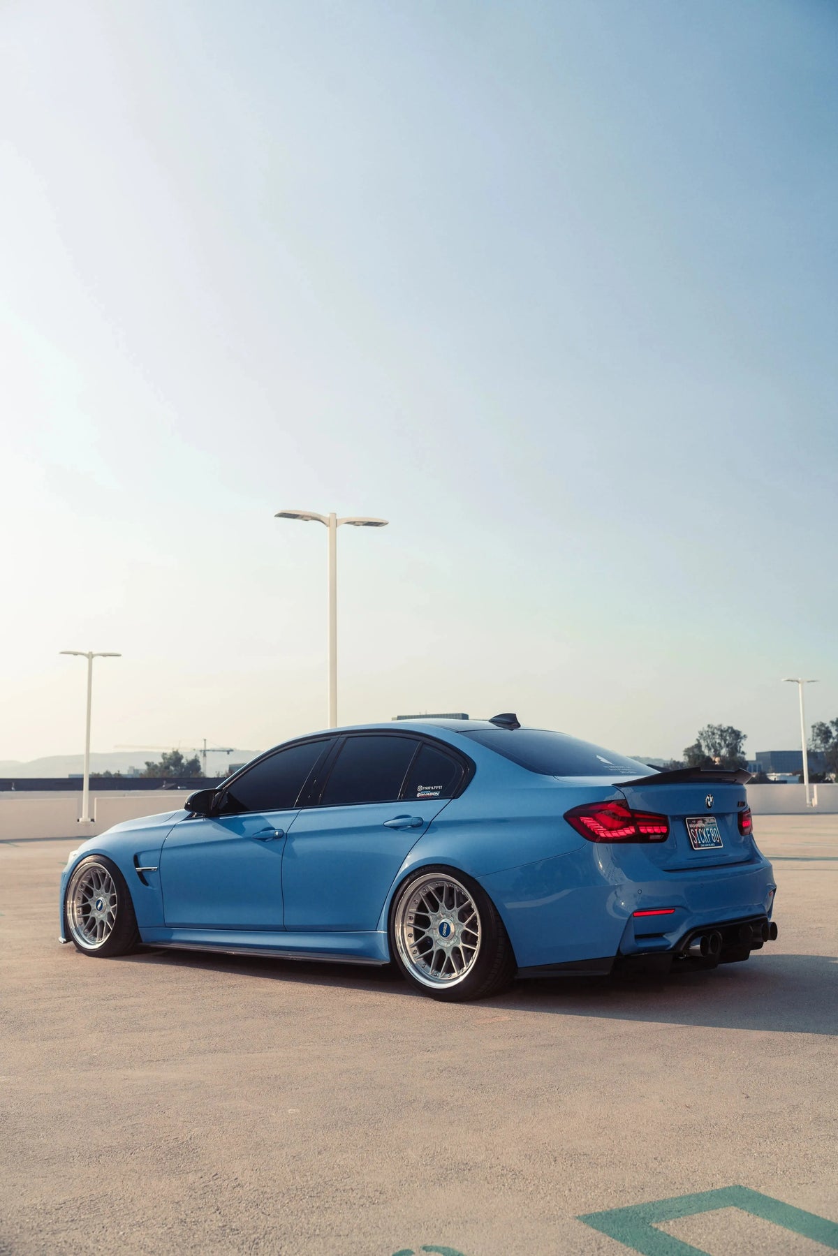 Blue BMW F80 M3 in a parking garage from the side-rear, red OLED tail lights (GTS Style)