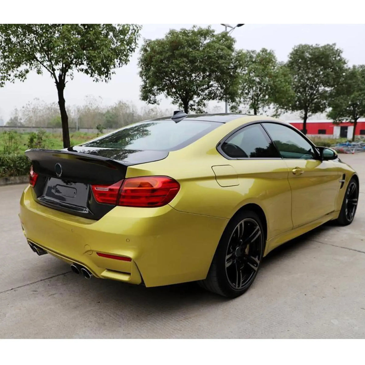 Yellow BMW M4 in rear three-quarter view, with fitted carbon trunk lid (GTS Style)