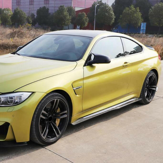 Yellow BMW M4 with fitted carbon side skirt, front-side three-quarter view (PSM Style)