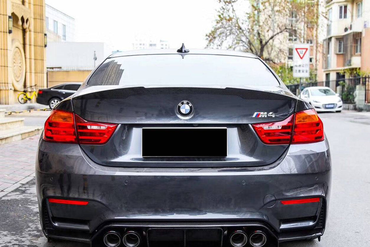 Gray BMW M4 rear view, with fitted carbon ducktail trunk spoiler (VRS Style)