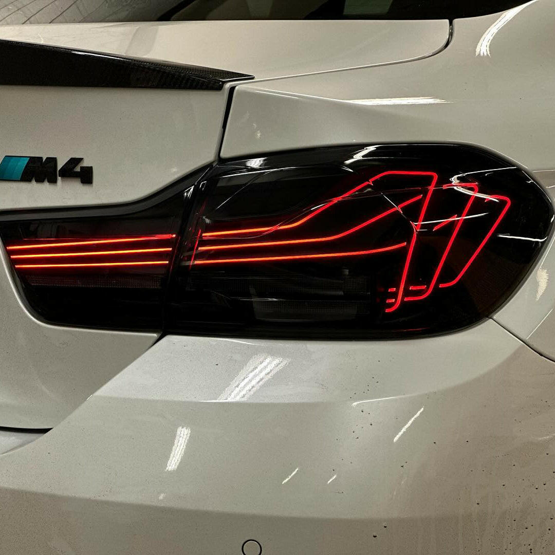 White BMW M4 rear close-up, with fitted smoked-lens laser tail light (CSL Style)