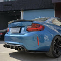 Blue BMW F87 M2, angled rear view, with fitted MTC Style carbon diffuser and side splitters