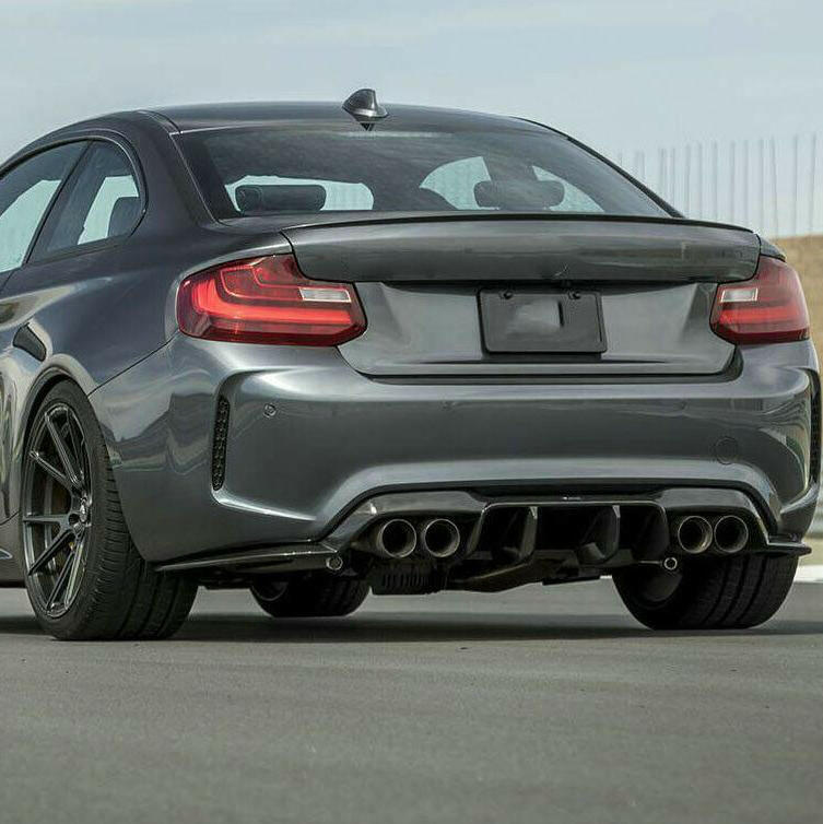 Gray BMW F87 M2, angled rear view, with fitted V Style carbon diffuser and side splitters