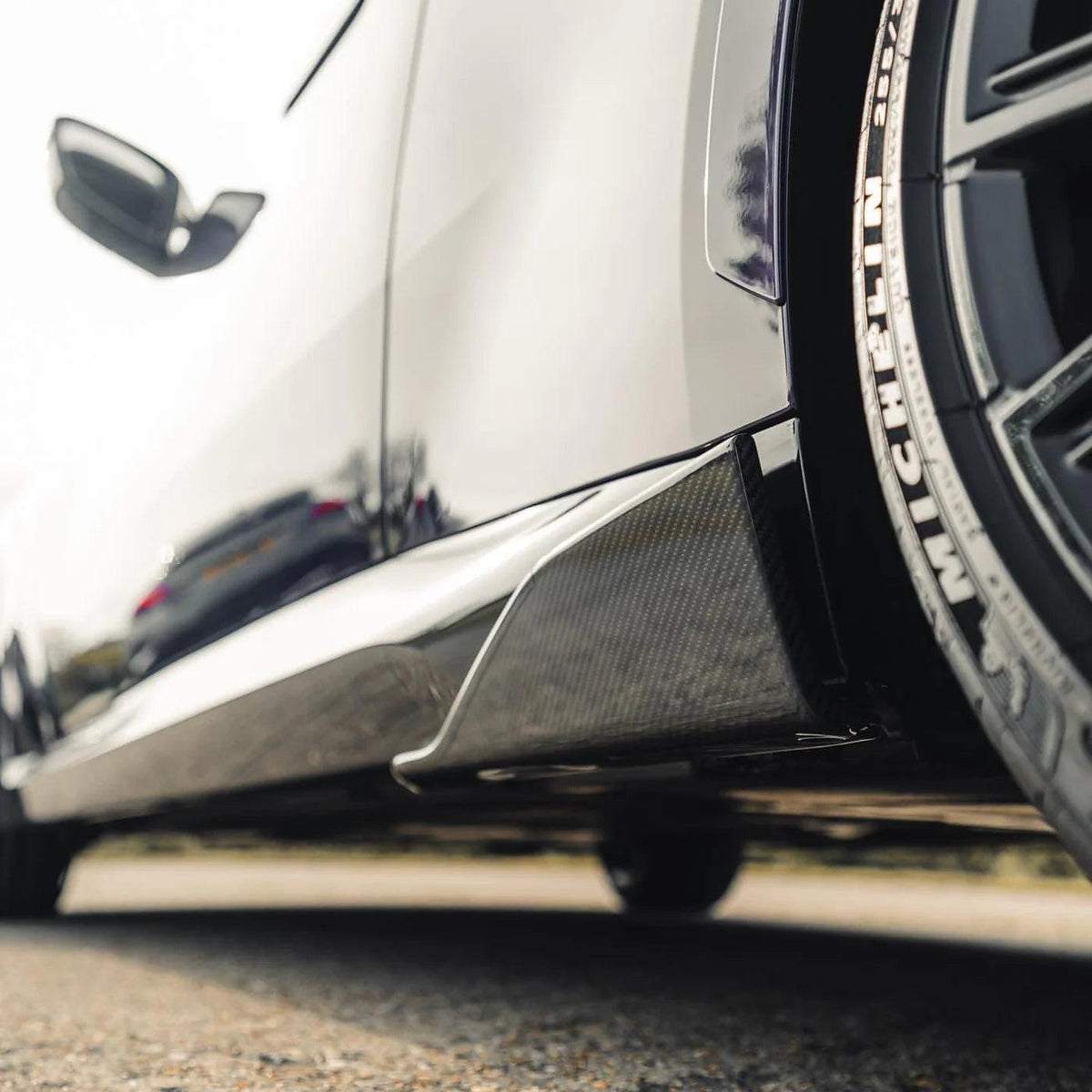 White BMW F87 M2 side sill with MP Style carbon fiber rear skirt end extension