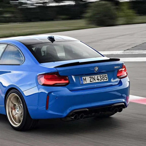 Kék BMW F87 M2 CS hátulról ferdén versenypályán, felszerelt CS Style carbon spoilerrel