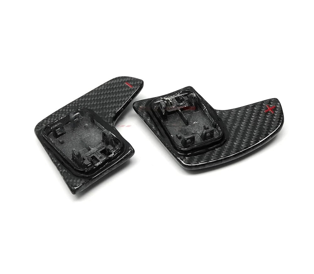 Mounting side of enlarged carbon paddle shifter pair, angled, on a white background – BMW G Series