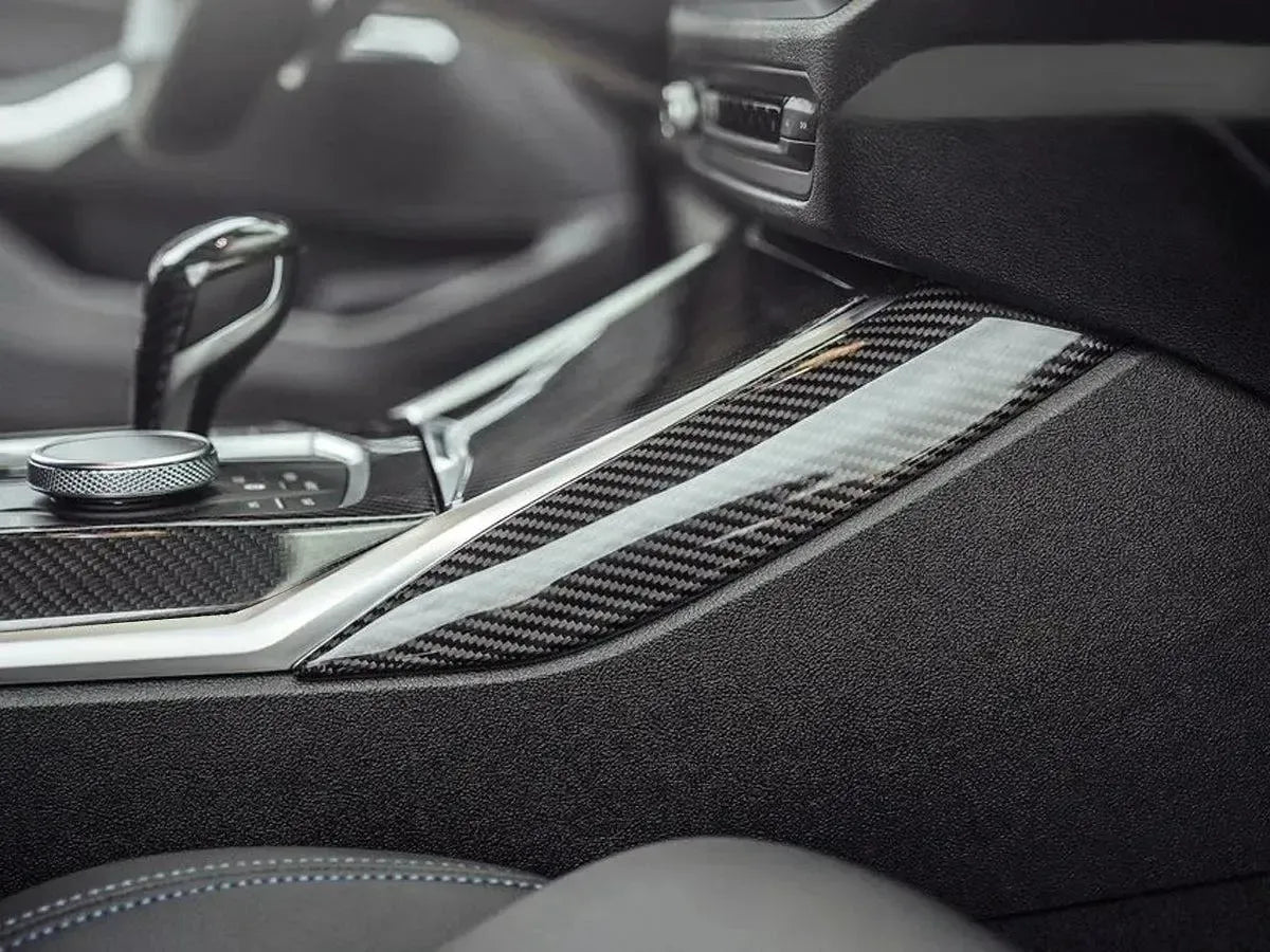 Side of a pre-LCI BMW G20 center console with gloss carbon trims