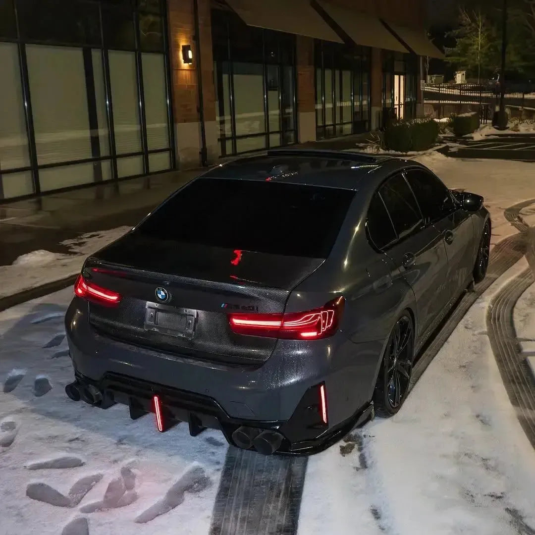 Gray BMW G20 M340i from the rear in the snow, with carbon trunk lid and four exhaust tips (CSL Style)