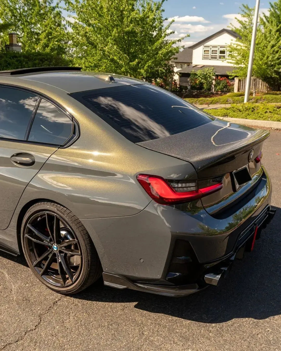 Olive gray BMW G20 LCI rear, three-quarter view, with fitted carbon trunk lid (OEM Style)