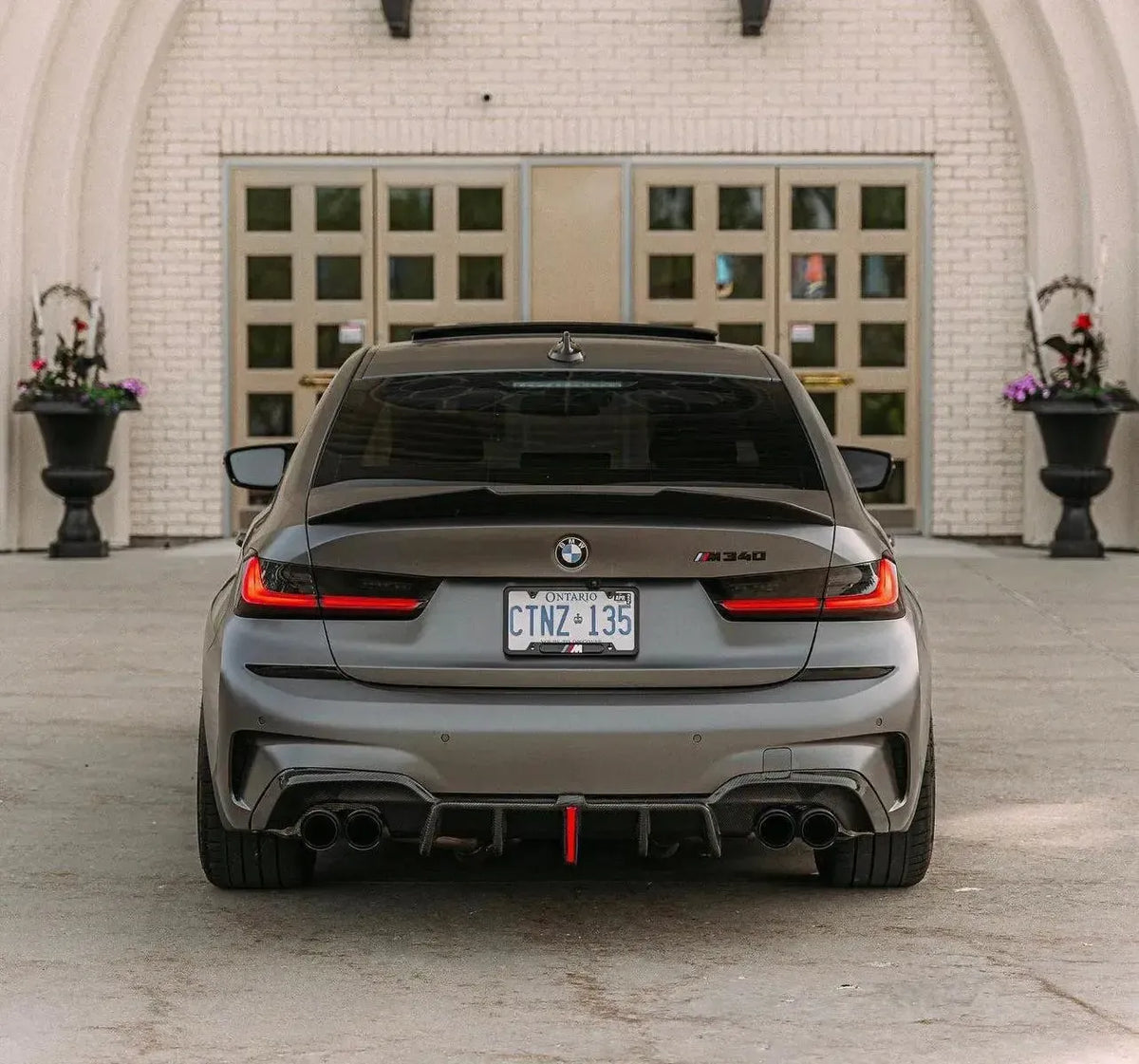 Gray BMW G20 M340i from the rear, with carbon rear diffuser and center red light (KB Style)