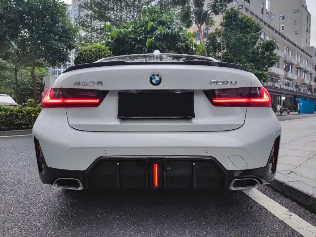 White BMW G20 LCI from the rear, carbon rear diffuser with illuminated red vertical brake light (TK Style)