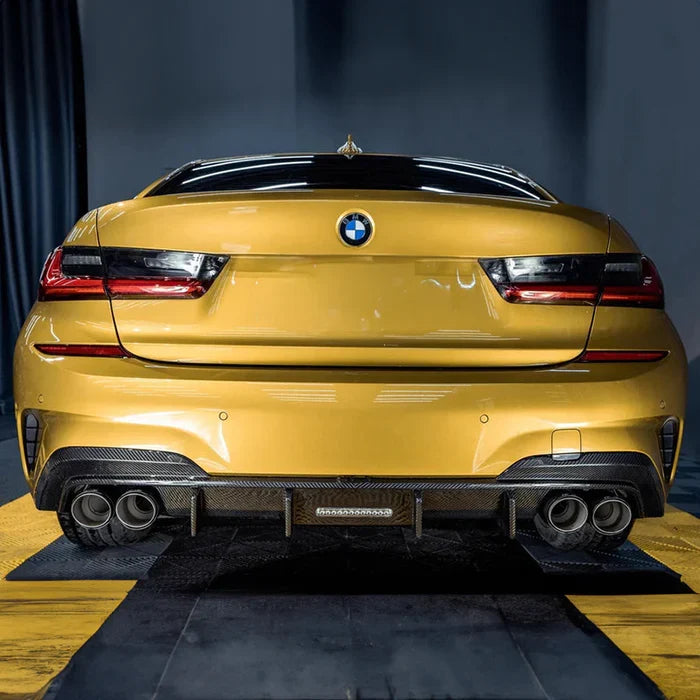 Yellow BMW G20 sedan from the rear in a studio, with carbon rear diffuser and four exhaust tips (TK Style LED)