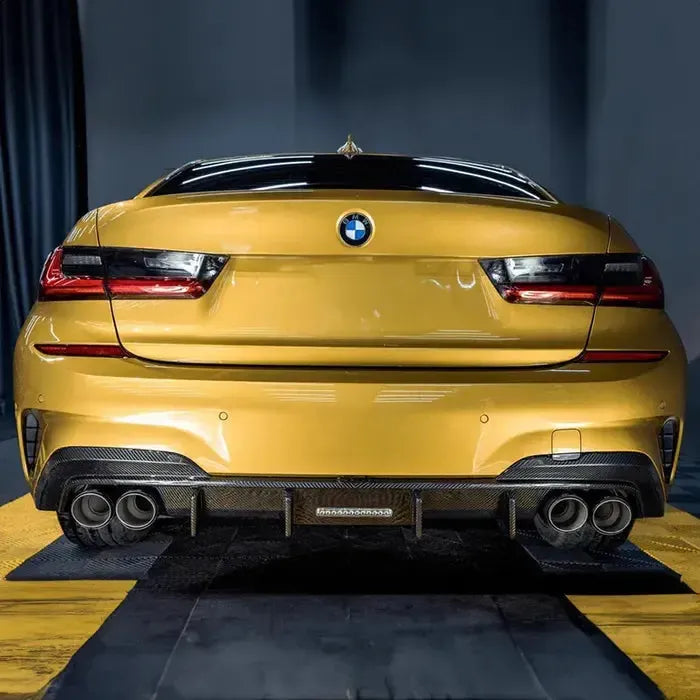 Yellow BMW G20 sedan from the rear, with fitted carbon diffuser and four exhaust tips (TK Style)