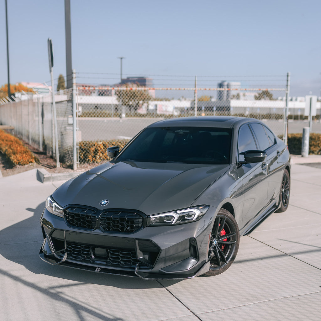 Gray BMW G20 LCI in a wider left front three-quarter shot, with carbon front lip (AD Style)