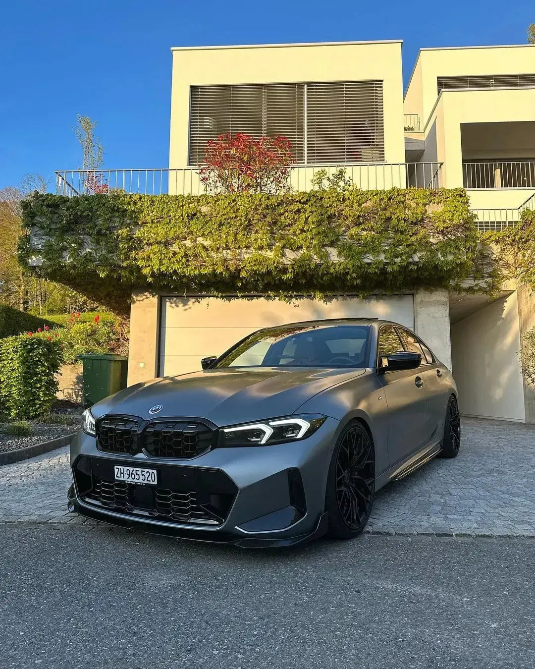 Gray BMW G20 LCI on a driveway, fitted with carbon front lip (MP Style)