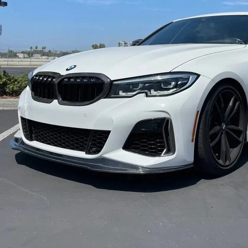 White pre-LCI BMW G20 M Sport, front three-quarter view, with carbon front lip (V Style)