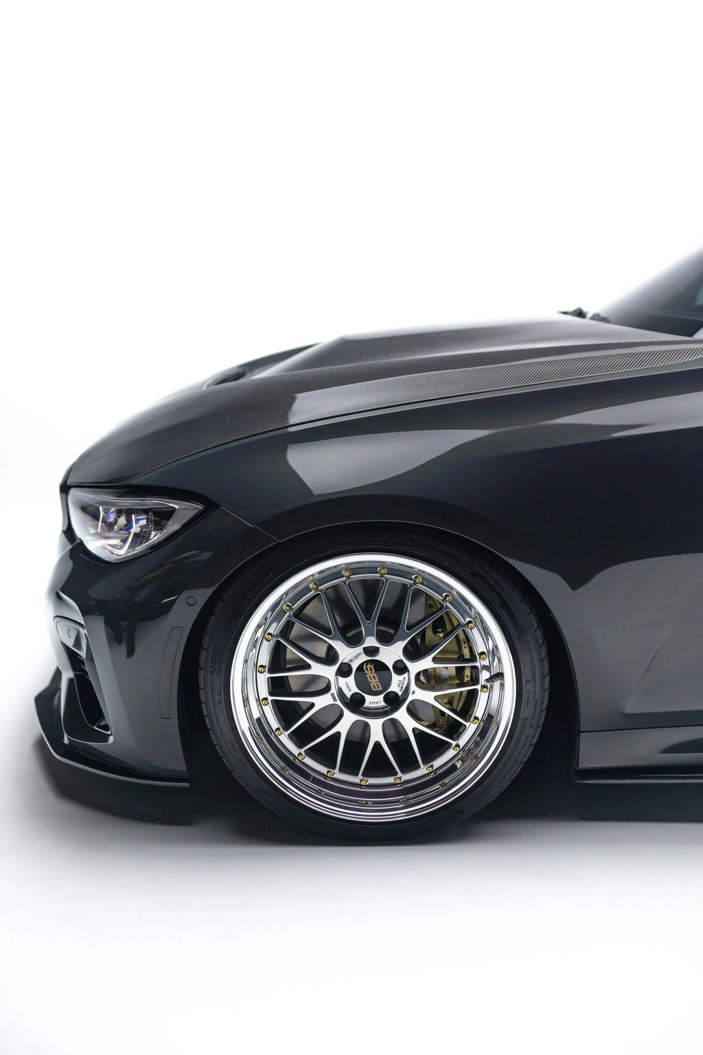 Black BMW G20 front from the side, close-up: carbon front lip corner and the wheel (V Style V2)